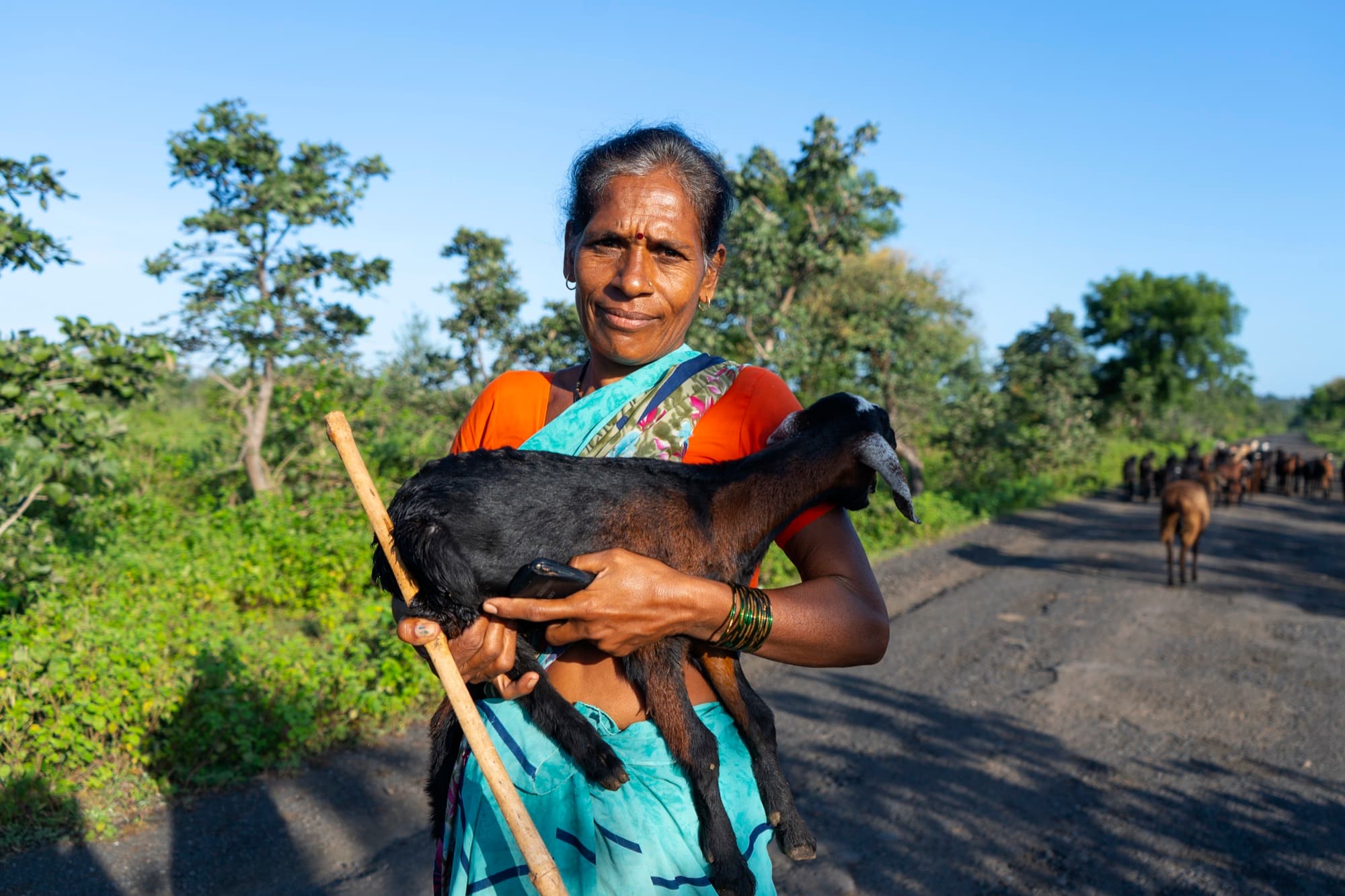 Farmer holding a goat, illustrating the range of species supported